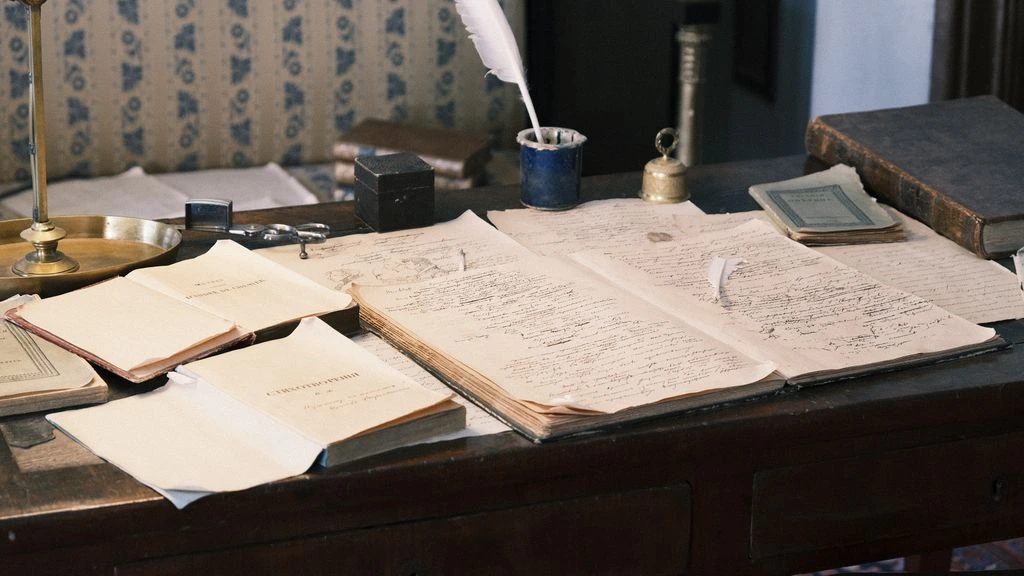 A writer's desk at dawn with an open notebook and fountain pen.